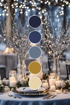 a table topped with candles and vases filled with white frosted trees covered in lights