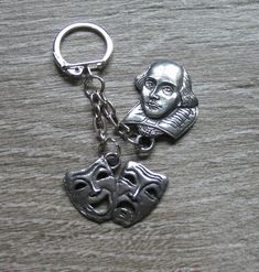 a keychain with a piece of metal on it that has a man's face in the middle