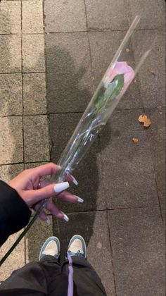 a person holding a bouquet of flowers on the sidewalk