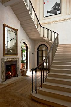 a staircase leading up to a fire place in a living room next to a fireplace