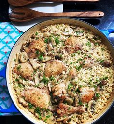 a pan filled with chicken and rice on top of a table