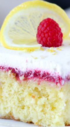 a piece of cake with raspberry and lemon on top