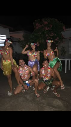 the hula dancers are posing for a group photo together in front of a building