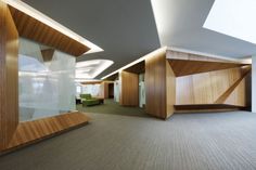 an empty room with wood paneling on the walls and carpeted floor is shown