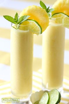 two tall glasses filled with cucumber and lemonade