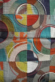 an abstract quilt with circles on it