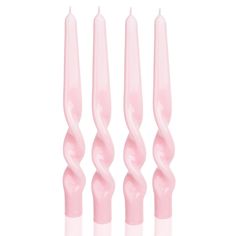 four pink candles sitting next to each other