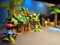 the stage is set up for a play with plants and mushrooms on it's sides