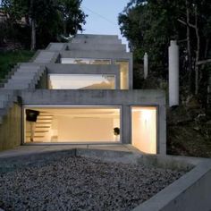 a concrete house with stairs leading up to it