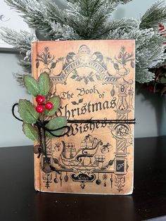 the book of christmas stories is decorated with holly