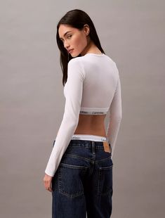 A Calvin Klein icon. This modern cotton t-shirt bralette is the definition of effortless. Cut in a form-fitting silhouette, this bralette is styled with long sleeves and a crewneck. Made with super soft and supple cotton stretch for all day comfort. Designed with the original Calvin Klein logo band, this is a sporty look that feels sexy everyday. Calvin Klein Aesthetic, Calvin Klein Outfits, Calvin Klein Sports Bra, Sports Bra Outfit, Masc Outfits, Sporty Look, Bra Women, Cotton T Shirt, Bralette