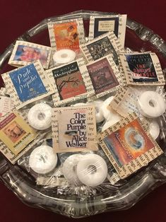 a glass bowl filled with lots of different types of buttons