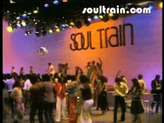 a group of people standing on top of a dance floor in front of a sign