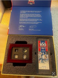 a display case with some baseball memorabilia on it's sides and an autographed card