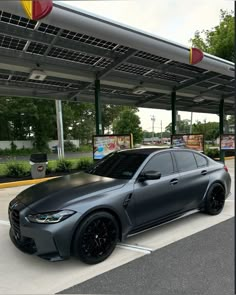 a grey car parked in front of a gas station