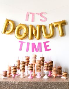 it's doughnut time party with donuts and gold balloons