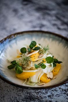 a white bowl filled with food on top of a table