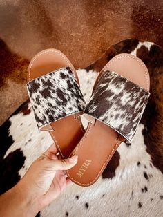 Genuine cowhide sandals! These are perfect for your Nashville trip or even just brunch out! Cowhide will be dark (blacks/greys/chocolate browns) or light (chestnut browns, white, tans). often shoes will have white speckles and  spotting but can be solid as well. If you are particular about the pattern you receive please reach out and I'm more then happy to send photos.   Cowhide is genuine  disclaimer: this is made with genuine cowhide so while you can choose a general color scheme the pattern/a Brown Round Toe Flip Flops For Outings, Comfortable Brown Sandals For Outings, Brown Leather Footbed Mules For Vacation, Cowhide Sandals, Western Sandals, Cowhide Shoes, Light Chestnut Brown, Cow Hide Shoes, Casual Country Outfits