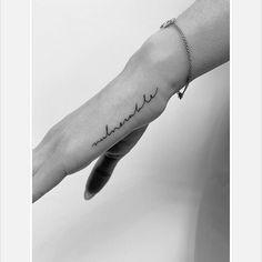 a person's hand with the word love written on it, in black and white