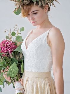 Our bohemian bridal lace top features a deeper V in the front (although of course we can always make it more modest upon request) and a shallow V in the back. It has built in cups and thus does not require one to wear a bra on their big day and is long to the hips, but it is not a bodysuit as we felt it didn't have to be, it does not require vertical pull to look great. The top features thick cotton, royal pattern style lace over most luxurious, soft matte and stretchy bridal satin and is then f Wedding V-neck Camisole With Delicate Straps, Delicate Lace Cami Top, Elegant Lace Tops With Sweetheart Neckline, V-neck Lace Top For Wedding, Camisole Wedding Dress With Lace Bodice, Elegant Tops With Spaghetti Straps And Fitted Bodice, Elegant Fitted Camisole With Lace Back, Delicate Straps Fitted Camisole For Wedding, Feminine Lace Top For Summer Weddings