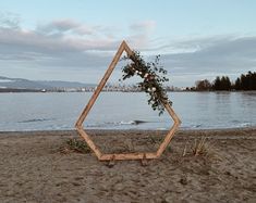 an odd shaped object sitting on top of a sandy beach