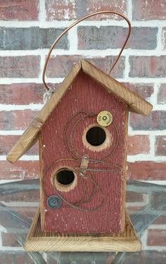 a birdhouse with two holes in the roof