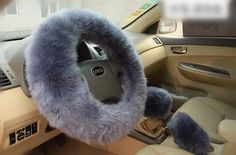 a car steering wheel cover with fuzzy fur on the front and center console, in grey