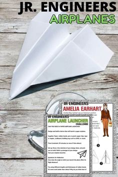 an origami paper airplane with instructions on the front and back side, sitting on top of a wooden table