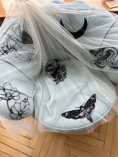 several bags with designs on them sitting on the floor