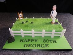 a birthday cake for a man with a lawn and fence on it that says happy 80th george