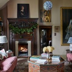 a living room filled with furniture and a fire place in front of a painting on the wall