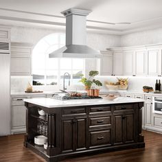 a kitchen with white cabinets and an island in the middle of the room, surrounded by wood flooring