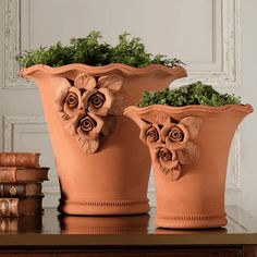 two clay flower pots sitting on top of a table