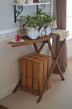 a wooden table with some plants on top of it and a basket next to it