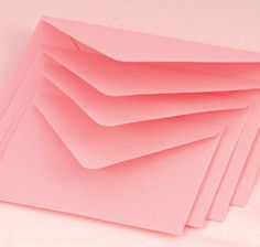 pink paper stacked on top of each other