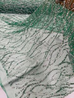 green and silver sequins on sheer fabric