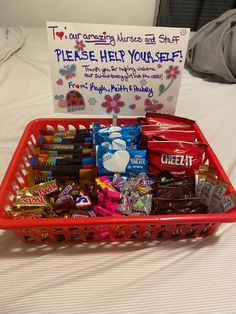 a basket filled with candy and candies on top of a bed