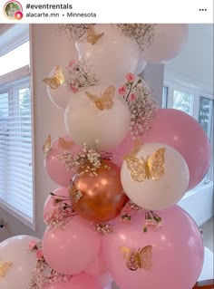 pink and white balloons with gold butterflies on them