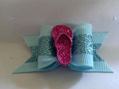 a blue and pink bow with sequins on it