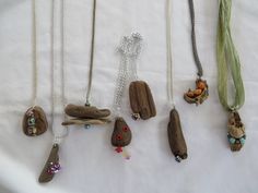 various necklaces are displayed on a white surface