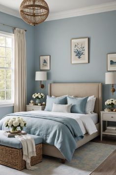 a bedroom with blue walls and white flowers on the bed, along with a wicker basket