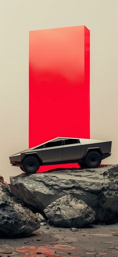 a black car is parked in front of a red box on some rocks and dirt