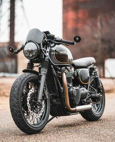 a black and gold motorcycle parked on the street