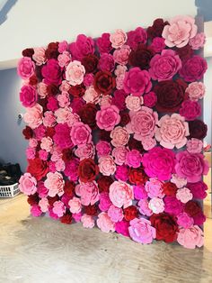 the wall is made out of pink and red flowers