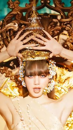 a woman with a crown on her head in front of a gold and blue background