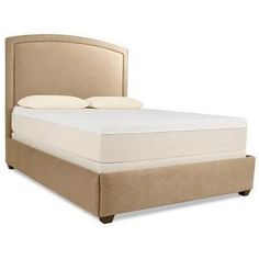 an upholstered bed frame with two pillows on the headboard and foot board