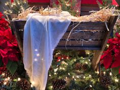 a wooden bench covered in christmas decorations and lights