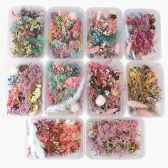 several plastic containers filled with different types of beads