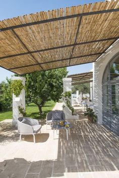 an outdoor covered patio with chairs and tables