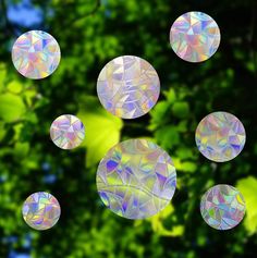 several bubbles are floating in the air near some trees